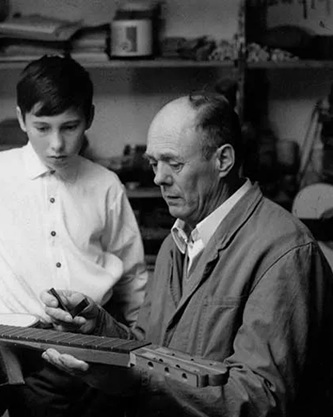 Hauser II teaching Hauser III on guitar making