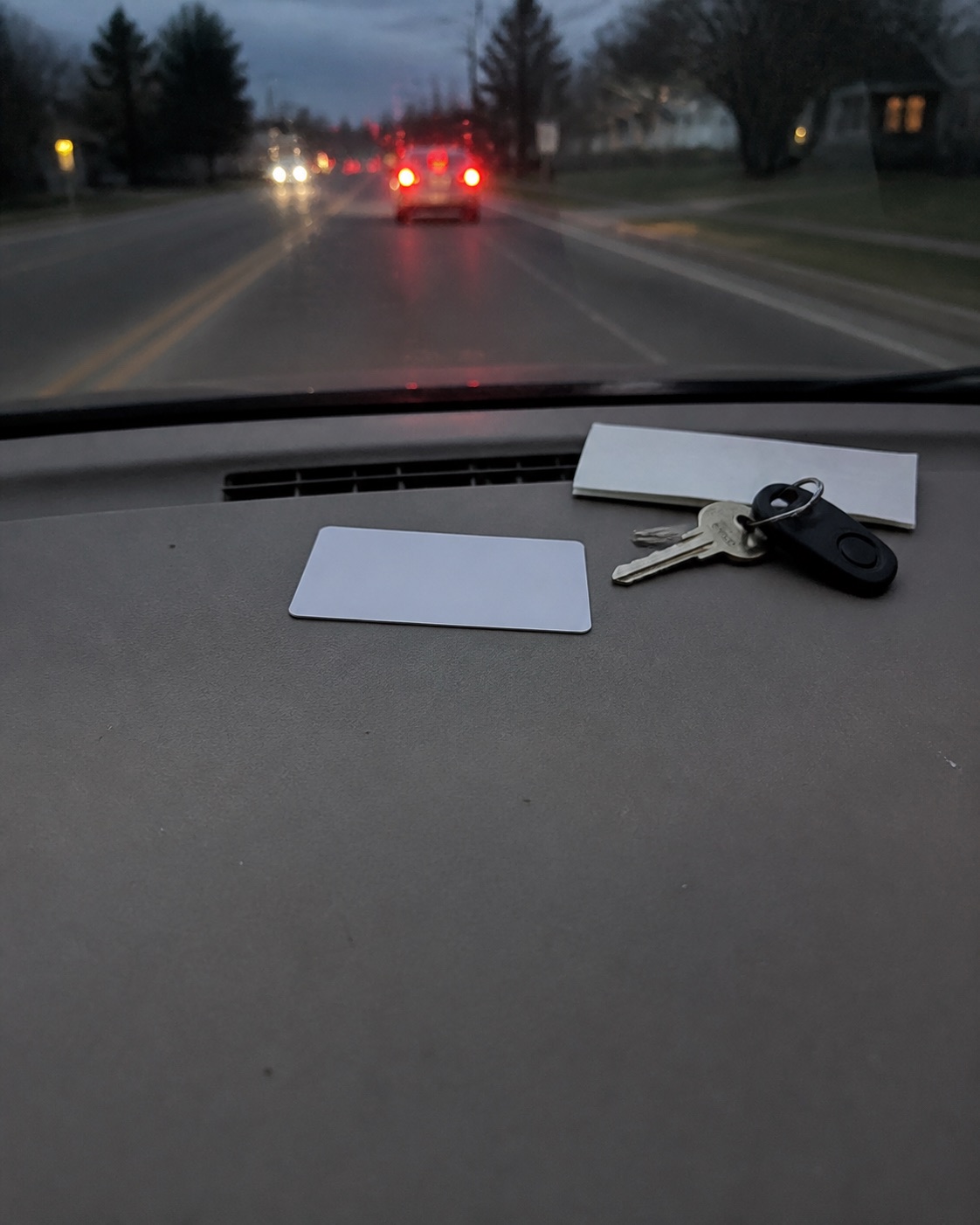 AI-generated illustration of blank cards and paper inside a car. Not actual insurance documents. Keep records secure rather than on a dashboard while driving.